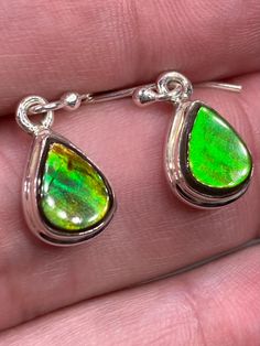 The shimmering, iridescent, green, red and orange reflection is intensely detailed in this pair of beautifully unique Ammolite and silver earrings. These stones were mined in Alberta, Canada. Earrings measurements - 1.0cm long x 0.8cm wide x 0.4cm deep. Drop - 2.8cm. Earrings weight - 2 grams (1 grams each), pear-cut, set in a classic 925 sterling silver bezel. Product made hypoallergenic with pure 925 silver and nickel, lead and cadmium free.  About the stone: Ammolite is actually one of the ra Mental Healing, Iridescent Green, Les Chakras, Red And Orange, Silver Dangle Earrings, Rare Gemstones, Alberta Canada, Etsy Earrings Dangle, Silver Earrings Dangle