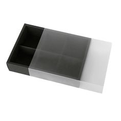 an empty black and white box sitting on top of a table