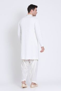 Ivory embroidered straight kurta featuring applique and resham work in geometric pattern. Paired with solid dhoti pant. - Aza Fashions Embroidered Off White Cotton Sherwani, Embroidered Off-white Cotton Sherwani, White Sherwani With Embroidered Border For Transitional Season, Transitional White Sherwani With Embroidered Border, White Cotton Sherwani With Cutdana, Traditional White Sherwani With Embroidered Border, White Embroidered Sherwani For Eid, Eid White Sherwani With Embroidered Border, Eid White Embroidered Sherwani