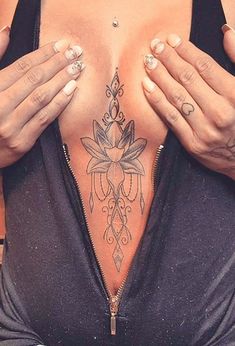 a woman with tattoos on her chest and arms