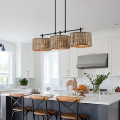 This farmhouse-style linear island chandelier light features matte black hardware and 3 drum shades which are meticulously hand-woven of natural rattan/wicker, making it a unique hanging pendant light for above the kitchen island and dining table or cafe bar. This collection can work with a variety of boho decors and even work in homes with coastal or farmhouse styling Bay Isle Home™ | Bay Isle Home™ Lannister 3 - Light Kitchen Island Drum Chandelier 10.4 H x 41.0 W x 11.0 D in black / brownMeta Kitchen Island And Dining Table, Island And Dining Table, Coastal Chandelier, Drum Pendant Lighting, Island Chandelier, Rattan Shades, Light Kitchen Island, Inspire Me Home Decor, Light Kitchen