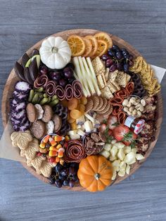 a wooden platter filled with different types of snacks