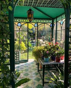 the inside of a green house with lots of potted plants and flowers in it