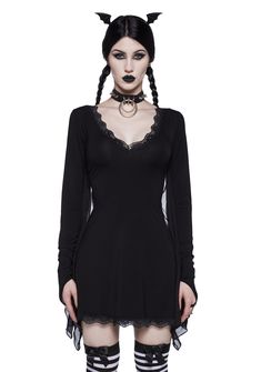 a woman with black makeup and cat ears on her head is dressed in goth clothing