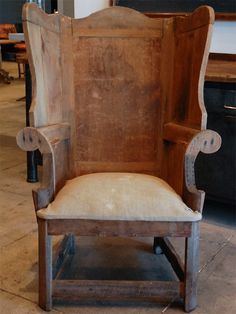 an old wooden chair sitting on top of a tile floor