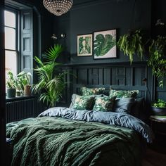 a bedroom with dark green walls and lots of plants