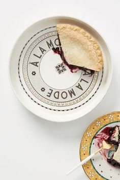 a piece of pie sitting on top of a white plate next to a small bowl