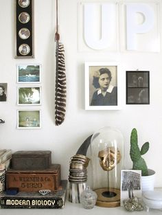 a white desk topped with lots of pictures and knick knacks