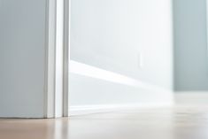 an open white door on the floor in a room