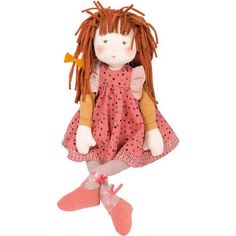 a doll with long red hair wearing a pink dress and orange socks is sitting on the floor