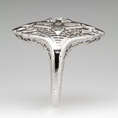 a silver ring with an intricate design on it