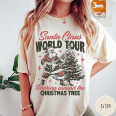 Santa Claus World Tour Comfort Colors® T-Shirt, Retro Christmas Shirt, Vintage Christmas Shirt, Rocking Around Tshirt, Trendy Holiday Tee 🧵 HOW TO ORDER   - Pick your size and color from the drop down menus  - Review the sizing and color options in the listing photos  - Add the item to your cart and complete the checkout process  - We'll start working on your order right away! 🧵SIZING  - Please review the listing photos to see the size charts  - These photos will also show you how to order a regular/relaxed fit or an oversized fit 🧵PRODUCT DETAILS  - Comfort Colors 1717 garment-dyed t-shirt - made 100% with ring-spun cotton. The soft-washed, garment-dyed fabric brings extra coziness to your wardrobe while the relaxed fit makes it an excellent daily choice. The double-needle stitching th Christmas Tshirts Designs, Vintage Christmas Shirt, Retro Christmas Shirt, Christmas Tees, Retro Christmas, Christmas Shirt, Size Charts, Halloween Tshirts, World Tour