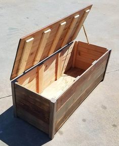 an open wooden box sitting on the ground