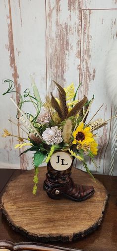 a vase filled with flowers sitting on top of a wooden table