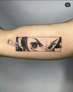 a woman's arm with an anime character tattoo on it