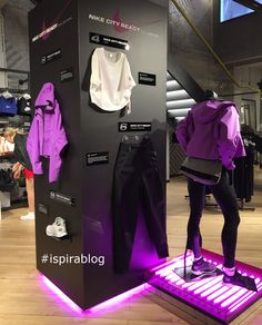 a display case with purple clothing on it