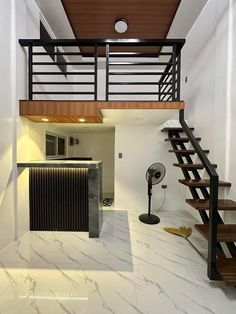 a staircase leading up to the second floor in a home with white walls and marble floors