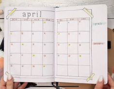 someone is holding up an open planner with the word'april'written on it