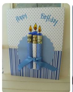 a birthday card with two candles on it and a blue ribbon tied around the candle