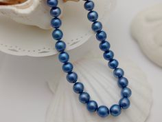 Material        : Genuine Natural Freshwater Pearls Quantity       : One Necklace Length         :  Please choose the length from the menu option Color            :  Royal Blue Baroque Pearls as pictured (color is dyed) Bead Shape : Irregular Baroque Pearls as pictured Bead Size       10-12 mm approx. Clasp  Size  :  14mm Spring Clasp Lead Time & Shipping :  This is an order to make item.  We will ship your order in 2-3 business day once order received.  If we offer FREE DOMESTIC shipping, package will be shipped via USPS First Class mail on orders shipping within the U.S.. Remarks : **This item is a custom order with length of your choice - this is non-returnable and non-exchangeable item once purchased**  D I S C O U N T   C O U P O N S :- Use coupon code :  SPECIAL10  ---->  10% Discoun Elegant Blue Pearl Necklace For Formal Occasions, Blue Single Strand Pearl Necklace For Formal Occasions, Classic Blue Pearl Necklace For Gift, Formal Blue Single Strand Pearl Necklace, Elegant Blue Round Pearl Necklace, Blue Single Strand Pearl Necklace, Blue Single Strand Round Pearl Necklace, Baroque Pearl Necklace, Baroque Pearls