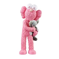 a pink teddy bear holding a stuffed animal