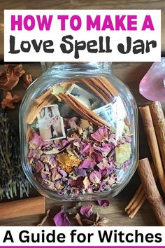 a jar filled with flowers and herbs next to cinnamon sticks