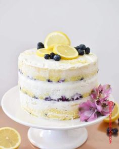 a cake with lemons and blueberries on top