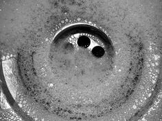 a black and white photo of a sink drain