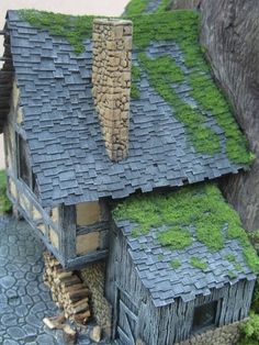 a model house with moss growing on the roof