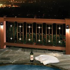 a bottle of wine sitting on top of a table next to a hot tub