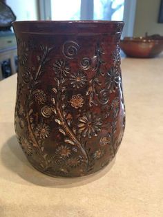 a brown vase sitting on top of a counter