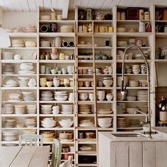 a kitchen filled with lots of white dishes