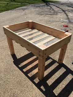 a wooden table sitting on top of a sidewalk