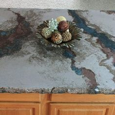 a granite counter top with some flowers in the center and other decorations on it's side