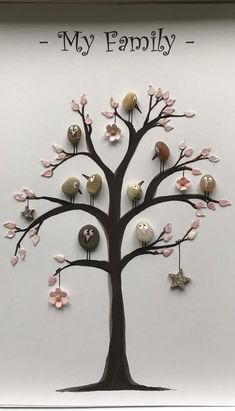 a family tree with birds and flowers on it is displayed in a shadow box frame