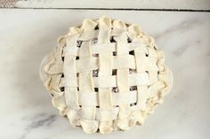 an uncooked pie sitting on top of a marble counter