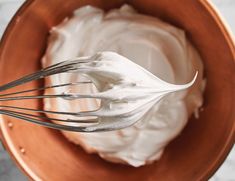 a bowl filled with whipped cream on top of a table