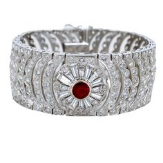 A breathtaking Art Deco style bracelet featuring a Burmese Ruby center stone. Masterfully hand-crafted in 18k White Gold. Feauting 13.21cts of Si-i1 Diamonds. Gemstone Details: Featuring a magnificent Burmese Ruby 2.24ct hearted round Carat Weight: 2.24 carat This stunning Ruby Diamond Bracelet is only available at Burdeen's Jewelry. Great gift idea for wedding or anniversary! We have many unique offerings of period fine jewelry posted on our Etsy store. Consider browsing all styles. Call us tod Luxury Multi-stone Diamond Bracelet For Formal Occasions, Luxury Multi-stone Diamond Bracelet, Luxury Ruby Bracelets, Luxury Round Ruby Bracelets, Luxury Round Ruby Bracelet, Luxury Multi-stone Diamond Bracelet For Wedding, Elegant Multi-stone Diamond Bracelets, Elegant Diamond Multi-stone Bracelets, Luxury Gemstone Cuff Bracelet For Weddings