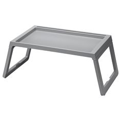 a metal tray that is sitting on top of a white table with two legs and one leg