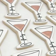 decorated cookies are arranged in the shape of martini glasses