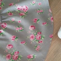 a close up of a cloth with flowers on it next to a hair dryer