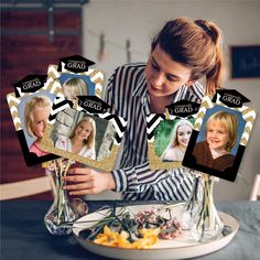 a woman sitting at a table in front of a plate with flowers and vases