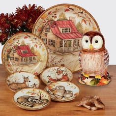 an owl figurine sitting on top of a table next to plates and bowls