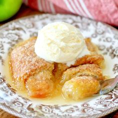 an apple cobbler on a plate with ice cream