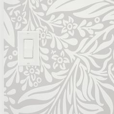 a light switch cover with a floral design on it's side and an ornate pattern on the back