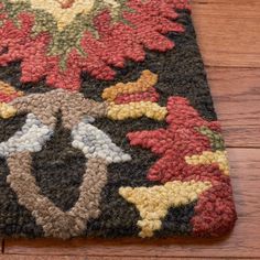 a close up of a rug on a wooden floor with a wood floor in the background