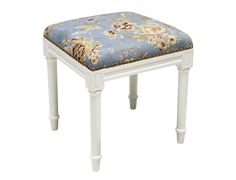 a white stool with a blue floral seat cover