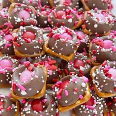 chocolate covered donuts with sprinkles and hearts