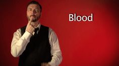 a man standing in front of a red background with the words blood written on it