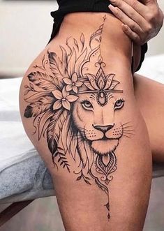 a woman with a lion tattoo on her thigh